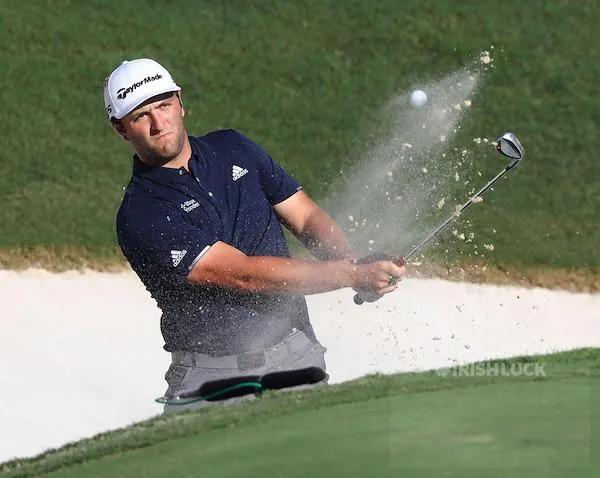 John Rahm hits out of a bunker to the 18th green to save his par and finish at 9-under during the second round of the Tour Championship at East Lake Golf Club in Atlanta on Saturday, Sept. 5, 2020.