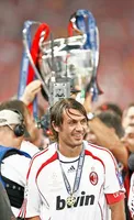 AC Milan's captain Paolo Maldini smiles as the European Cup is lifted behind him