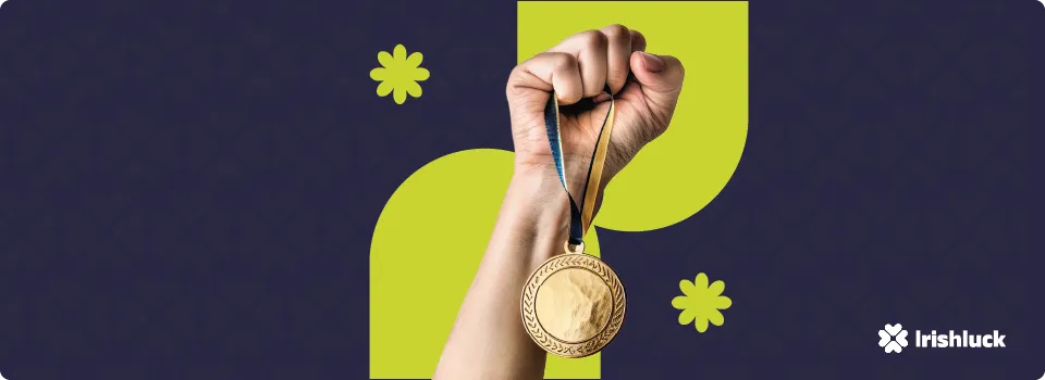 hand holding a gold medal with the irishluck on a blue and green background